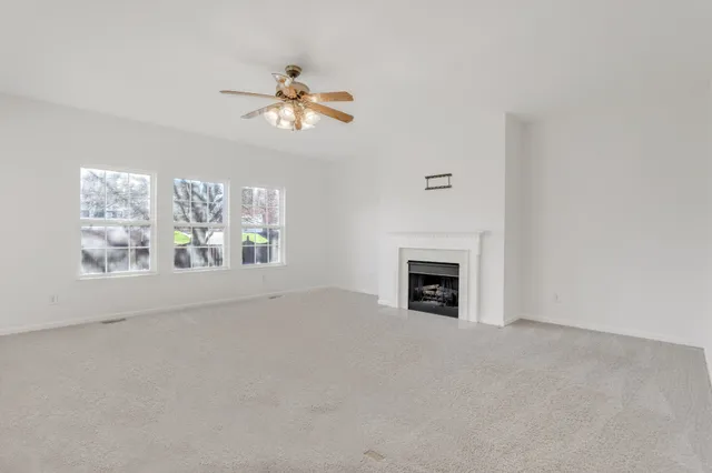 a view of a livingroom with a fireplace and window