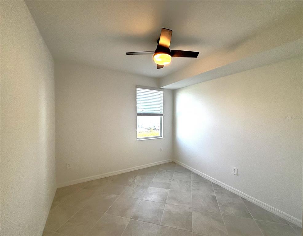 17680 Boracay Court, Unit 101 Venice, FL 34293 - Photo 13 of 42 an empty room with windows and painted walls