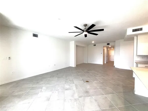 a view of a livingroom with a ceiling fan and window