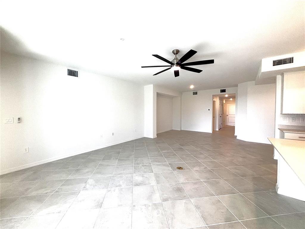 17680 Boracay Court, Unit 101 Venice, FL 34293 - Photo 6 of 42 a view of a livingroom with a ceiling fan and window