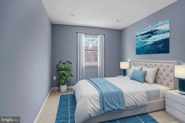 a bedroom with bed and large window