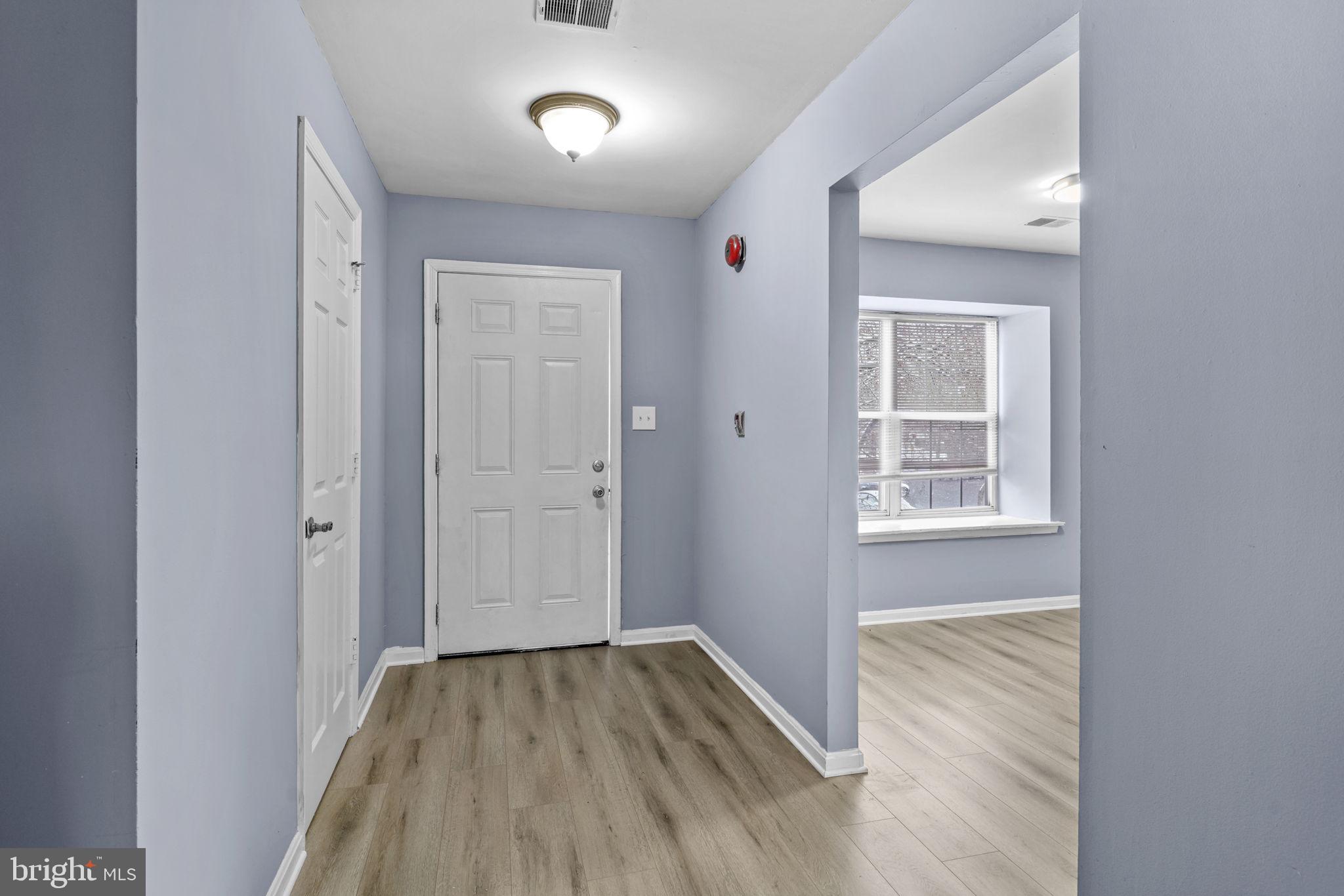 11206 Hannah Way, Unit 4 Upper Marlboro, MD 20774 - Photo 2 of 25 an empty room with wooden floor and windows
