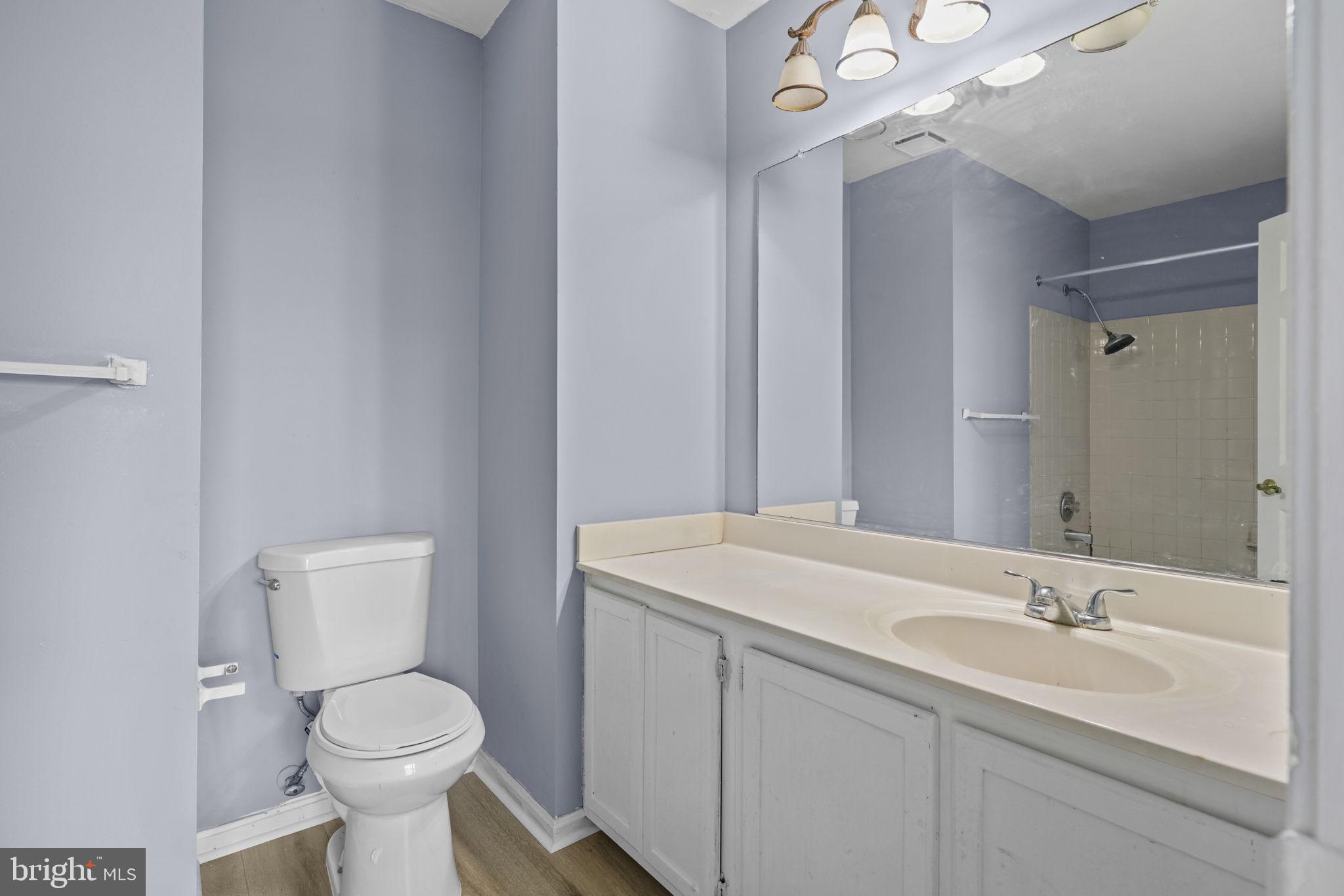 11206 Hannah Way, Unit 4 Upper Marlboro, MD 20774 - Photo 21 of 25 a bathroom with a sink a toilet a mirror and vanity