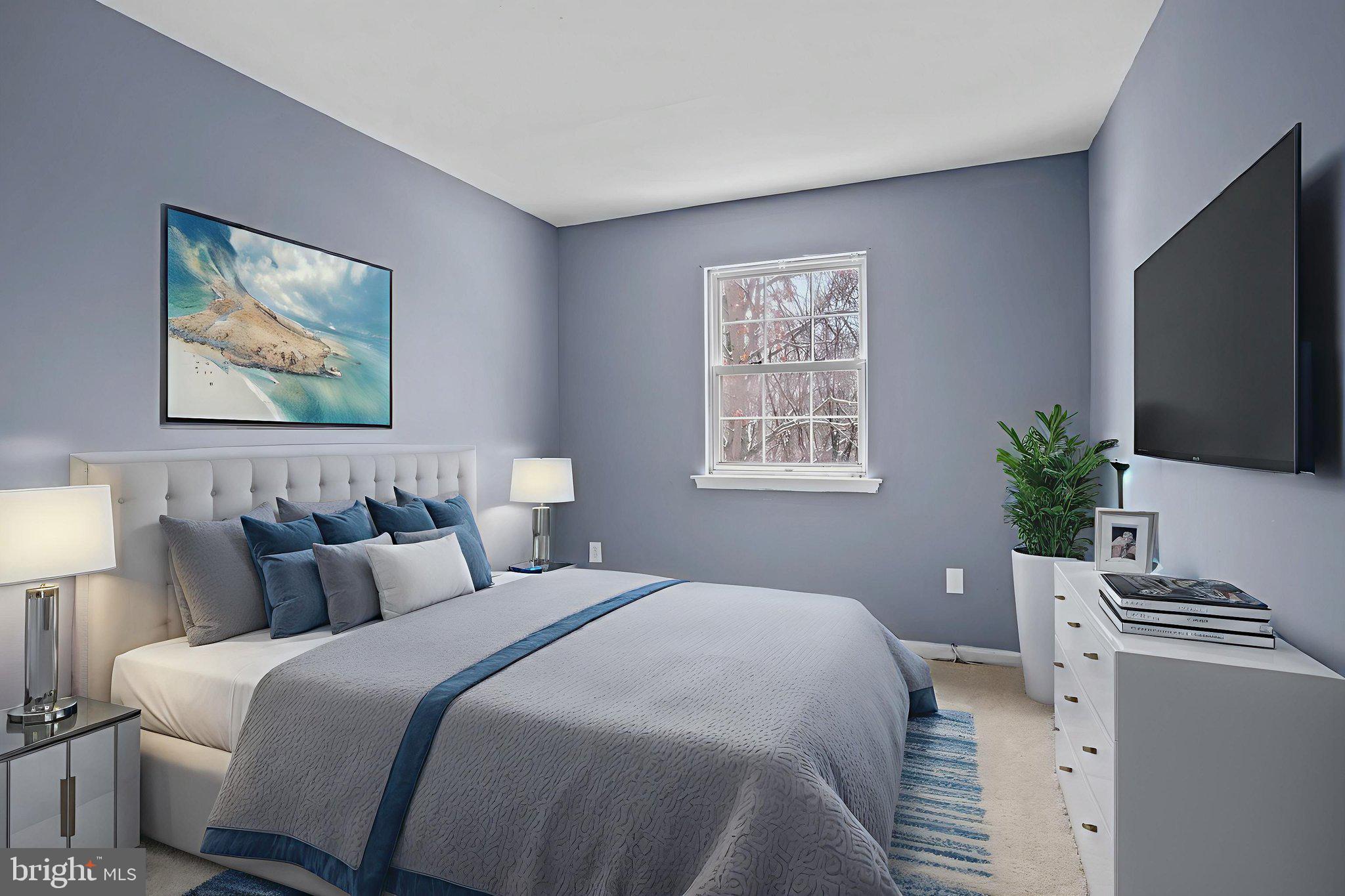 11206 Hannah Way, Unit 4 Upper Marlboro, MD 20774 - Photo 23 of 25 a bedroom with a bed a couch and a flat screen tv