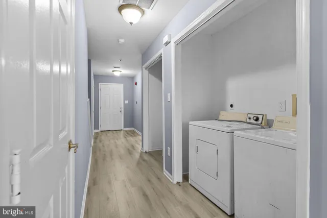 a view of hallway with wooden floor