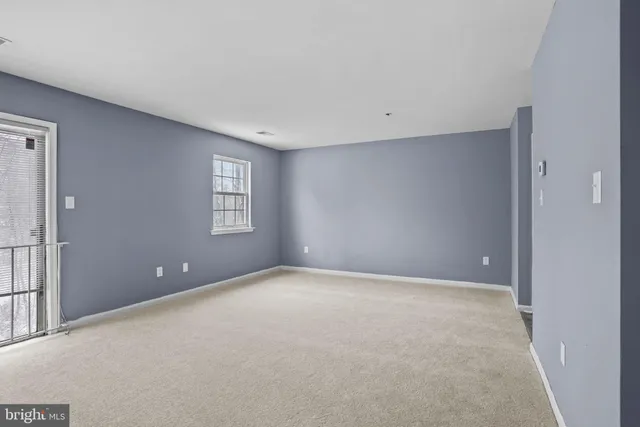 a view of an empty room with windows
