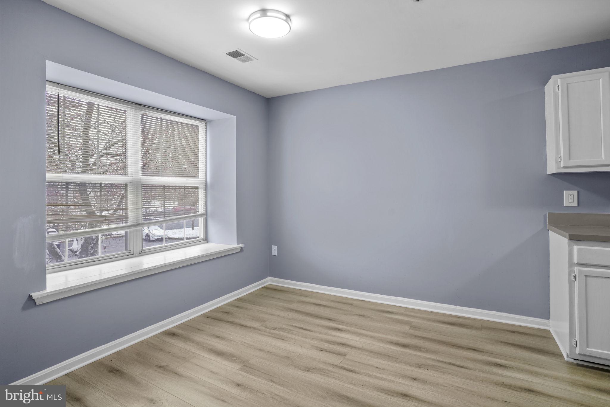 11206 Hannah Way, Unit 4 Upper Marlboro, MD 20774 - Photo 8 of 25 a view of empty room with wooden floor and fan