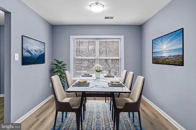 a view of a dining room with furniture window and wooden floor