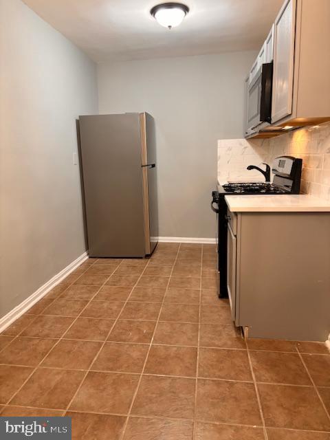 44 49th Street Southeast, Unit 302 Washington, DC 20019 - Photo 15 of 44 a kitchen with stainless steel appliances a sink a stove a refrigerator a microwave and cabinets