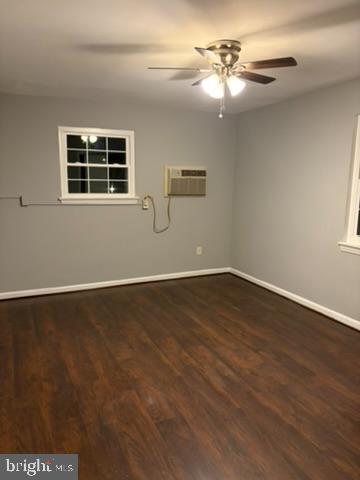44 49th Street Southeast, Unit 302 Washington, DC 20019 - Photo 29 of 44 an empty room with wooden floor chandelier fan and windows
