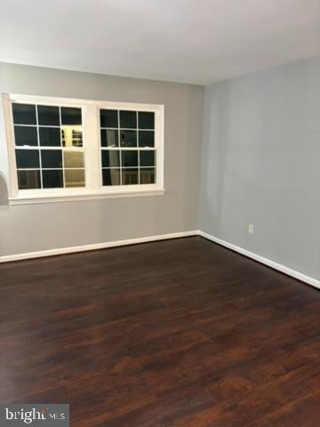 44 49th Street Southeast, Unit 302 Washington, DC 20019 - Photo 4 of 44 a view of an empty room with wooden floor and windows