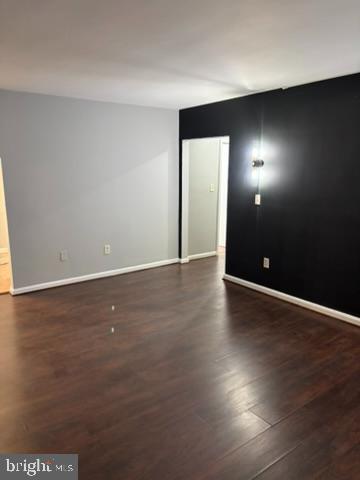 44 49th Street Southeast, Unit 302 Washington, DC 20019 - Photo 7 of 44 an empty room with wooden floor and windows