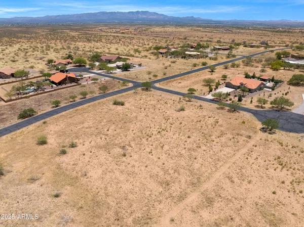 an aerial view of residential building and ocean view in back