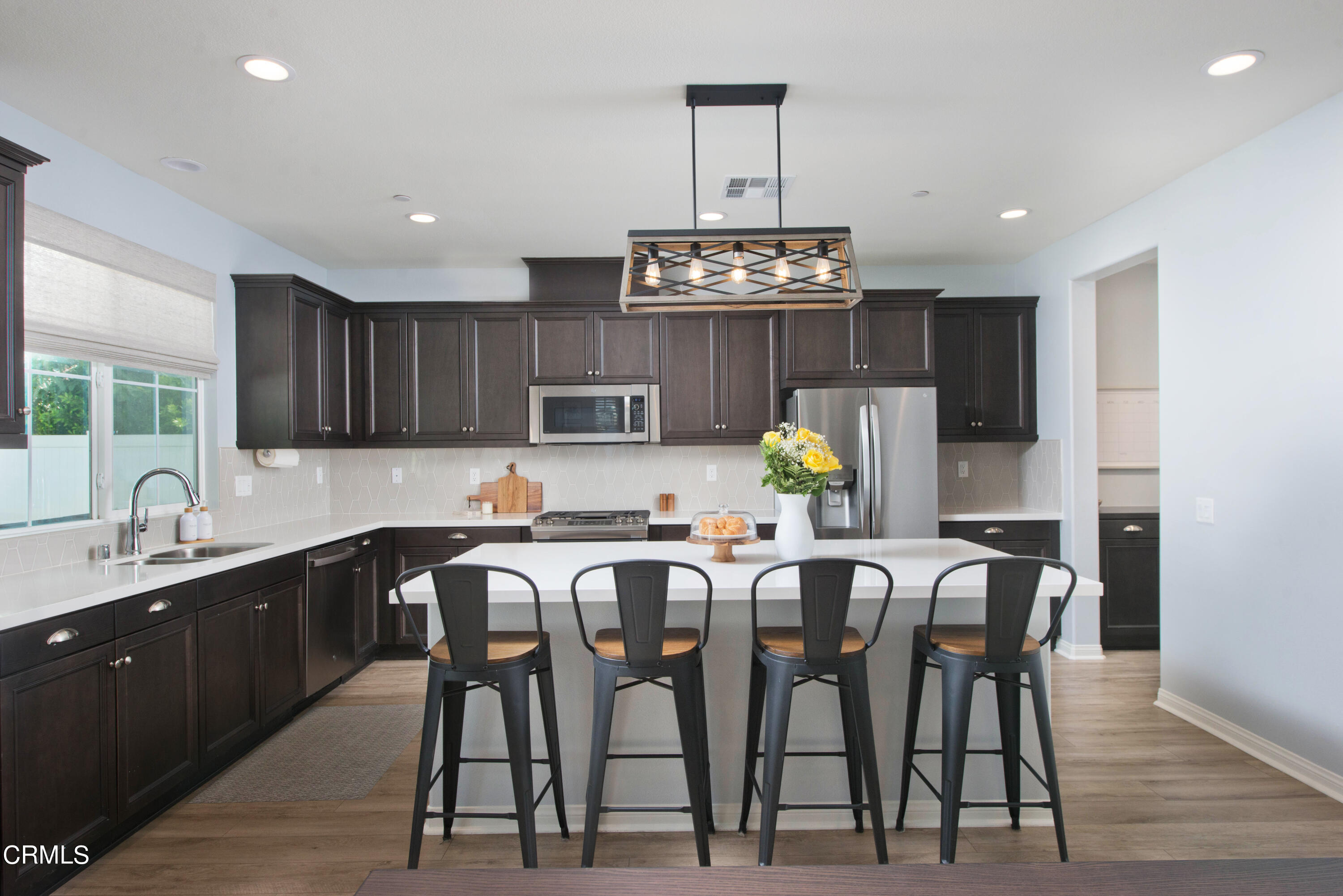 385 Azalea Street Fillmore, CA 93015 - Photo 11 of 50 a kitchen with cabinets and chairs in it