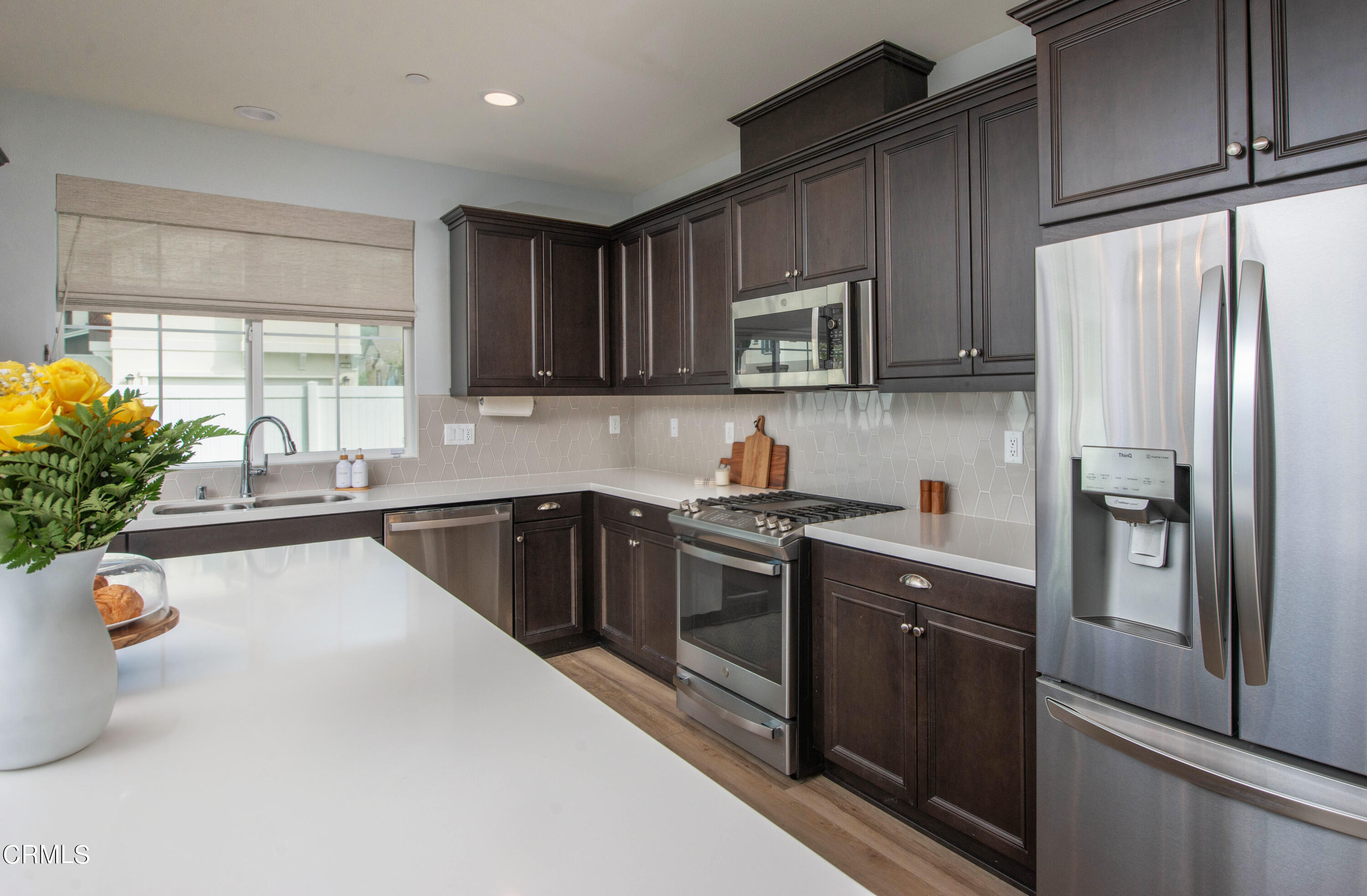 385 Azalea Street Fillmore, CA 93015 - Photo 12 of 50 a kitchen with a sink a refrigerator and a stove