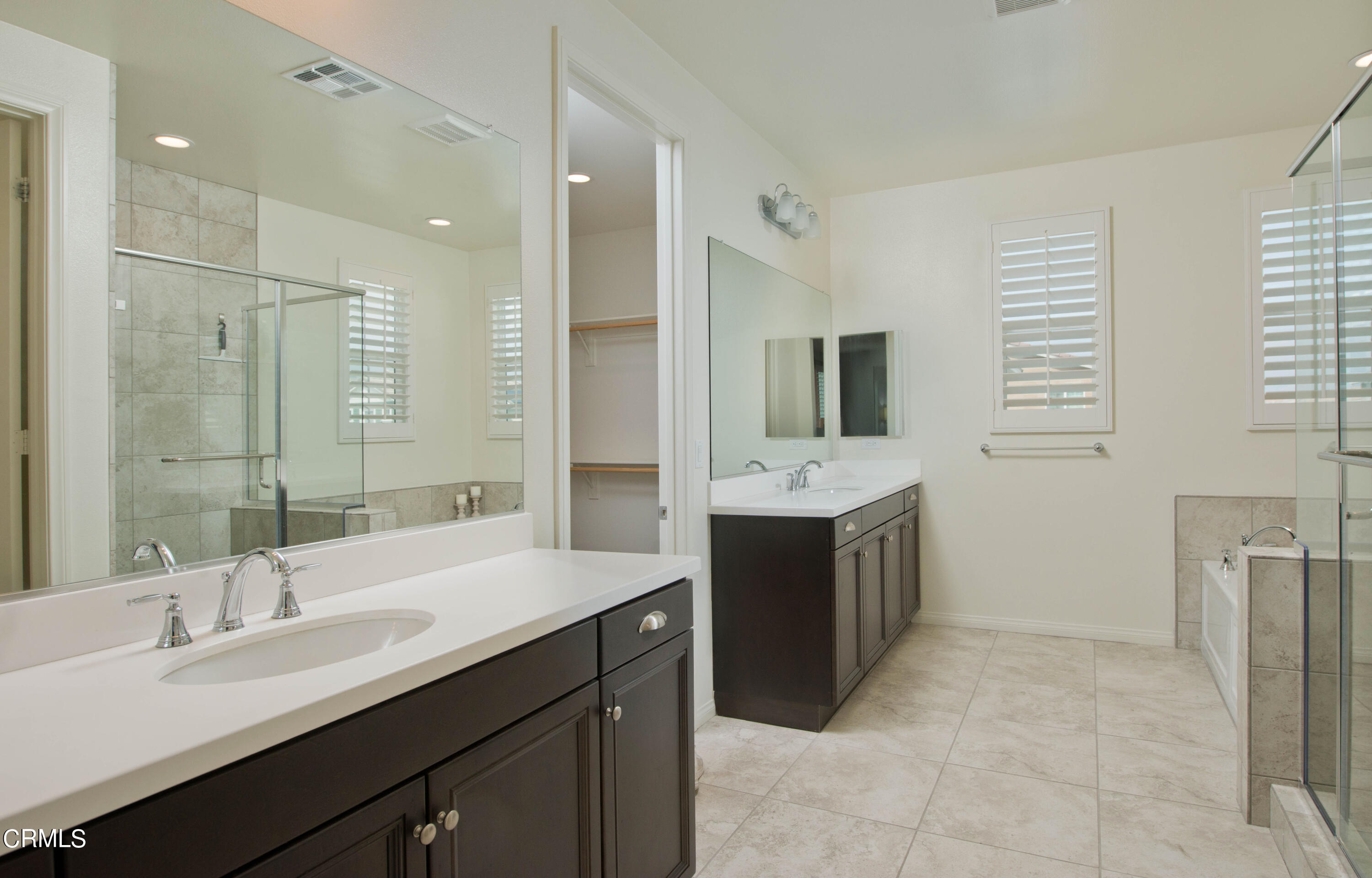 385 Azalea Street Fillmore, CA 93015 - Photo 31 of 50 a bathroom with a double vanity sink a mirror and a bathtub