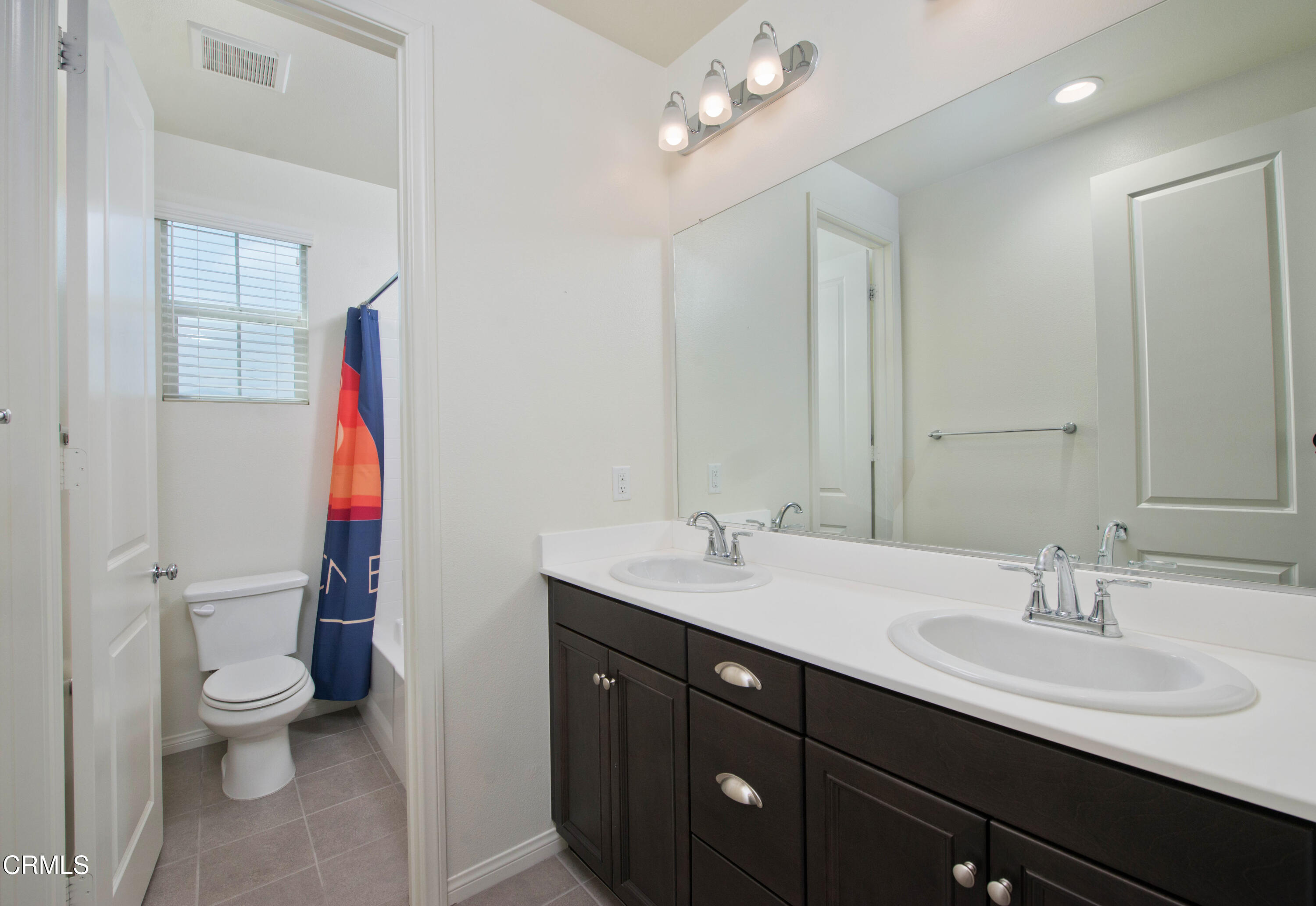 385 Azalea Street Fillmore, CA 93015 - Photo 35 of 50 a bathroom with a sink vanity mirror and toilet