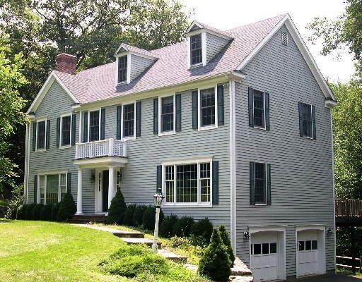 6 Harrison Court Ridgefield, CT 06877 - Photo 1 of 1 a front view of a house with a yard and garage