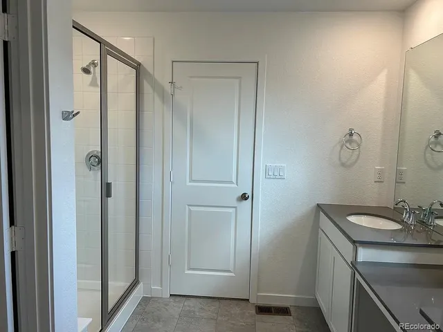 a white toilet sitting next to a bathroom sink