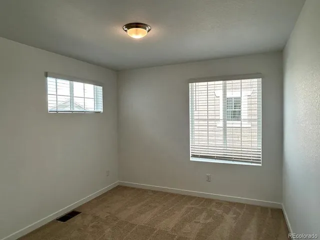 an empty room with closet area