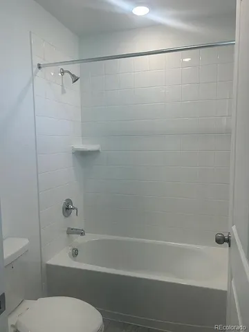 a white toilet sitting next to a bathroom sink