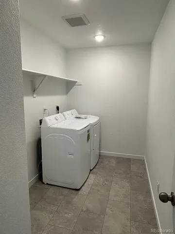 a view of empty room with wooden walls