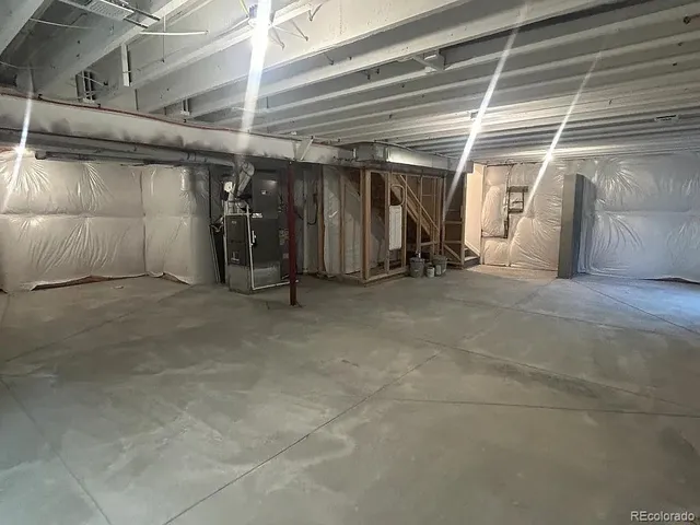 a view of a room with wooden floor and windows