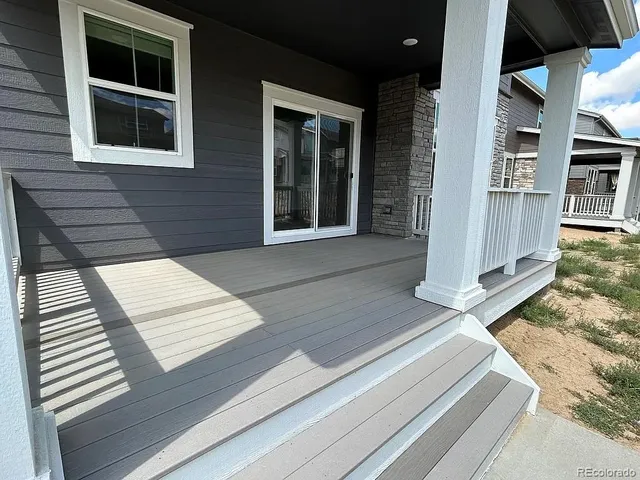 a view of a house with a yard and large tree