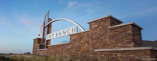 a view of a balcony with chairs and iron gate