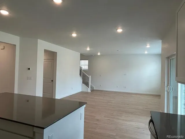 a kitchen with a refrigerator a microwave a sink and cabinets