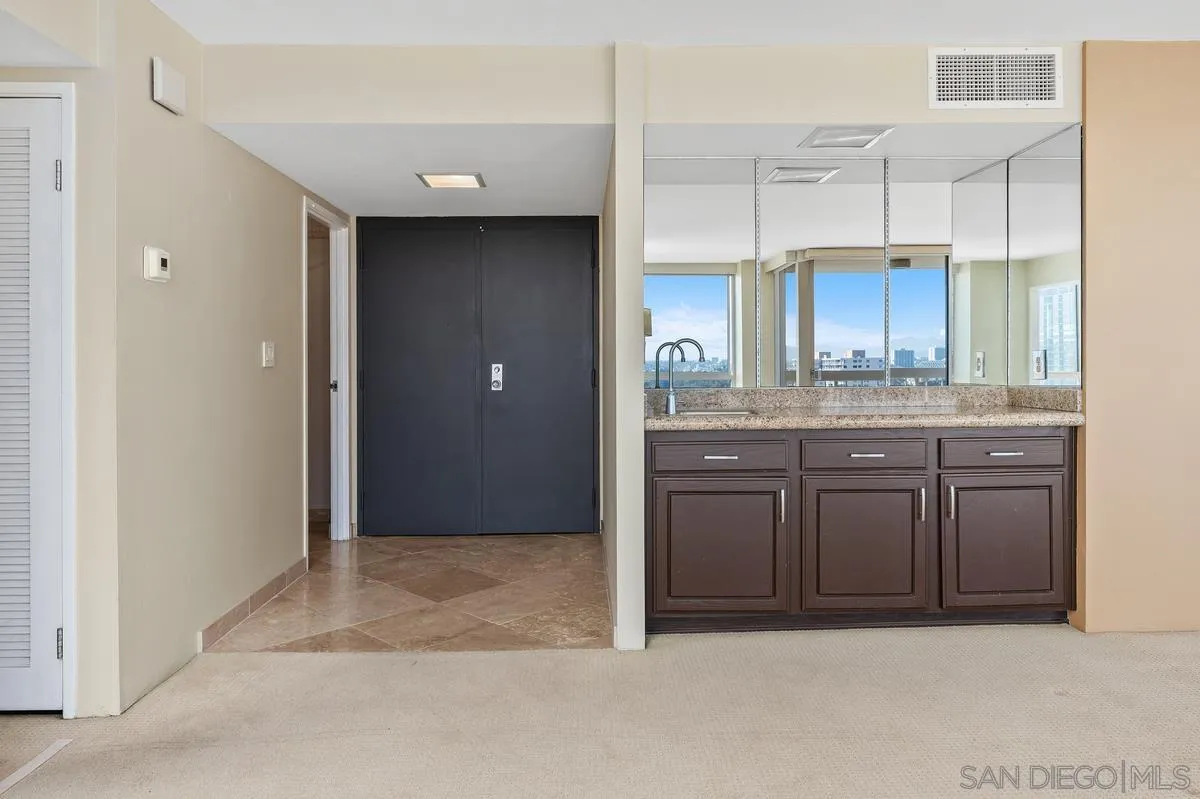 3535 1st Avenue, Unit 15A San Diego, CA 92103 - Photo 11 of 38 a kitchen with stainless steel appliances granite countertop a refrigerator and a sink