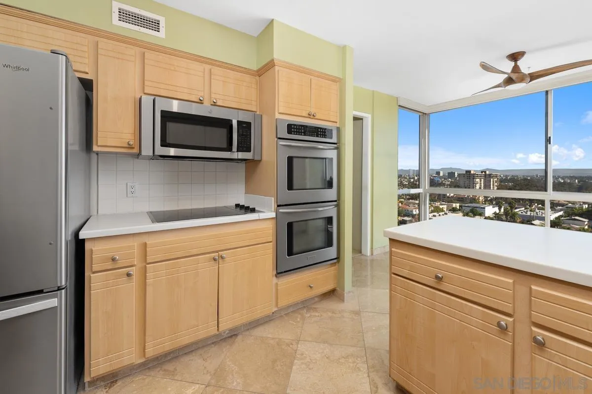 3535 1st Avenue, Unit 15A San Diego, CA 92103 - Photo 19 of 38 a kitchen with stainless steel appliances white cabinets and a refrigerator