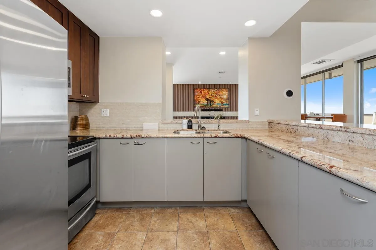 3535 1st Avenue, Unit 15A San Diego, CA 92103 - Photo 31 of 38 a kitchen with granite countertop a sink and a stove top oven
