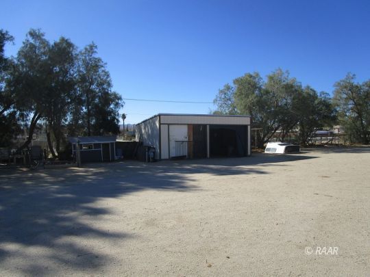 518 West Upjohn Avenue Ridgecrest, CA 93555 - Photo 16 of 24 a view of a house with a yard and garage