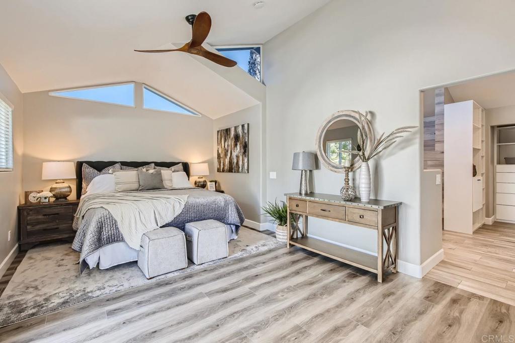 2015 Shadow Grove Way Encinitas, CA 92024 - Photo 12 of 27 a bedroom with a bed and a chandelier