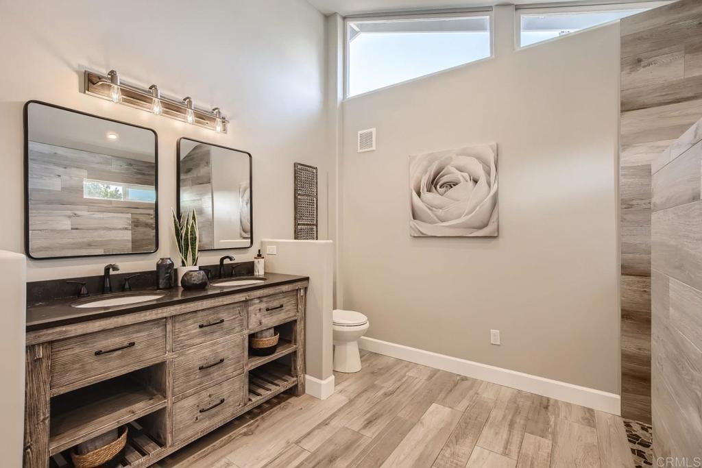 2015 Shadow Grove Way Encinitas, CA 92024 - Photo 14 of 27 a bathroom with a double vanity sink and a mirror
