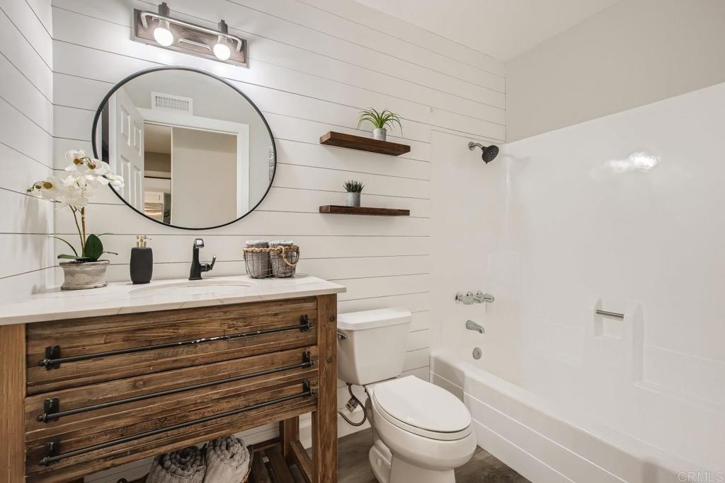 2015 Shadow Grove Way Encinitas, CA 92024 - Photo 21 of 27 a bathroom with a sink a toilet and a mirror