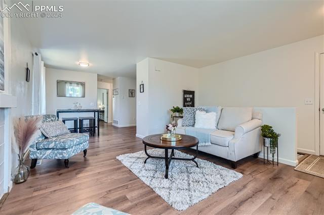 8234 Linderman Road Peyton, CO 80831 - Photo 4 of 24 Living room featuring hardwood / wood-style floors