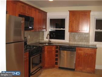 271 Copley Road Upper Darby, PA 19082 - Photo 1 of 12 a kitchen with granite countertop a refrigerator stove and microwave