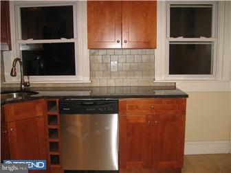 271 Copley Road Upper Darby, PA 19082 - Photo 3 of 12 a kitchen with granite countertop cabinets and black stainless steel appliances