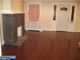 271 Copley Road Upper Darby, PA 19082 - Photo 9 of 12 a view of an empty room with wooden floor and a window