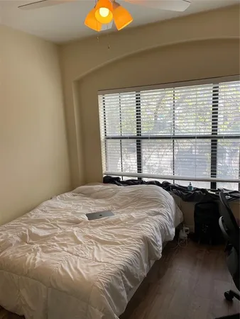 a bed sitting in a bedroom next to a window
