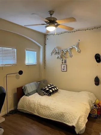 a bedroom with a bed and a painting on the wall