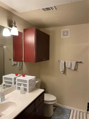 a bathroom with a sink vanity and a mirror