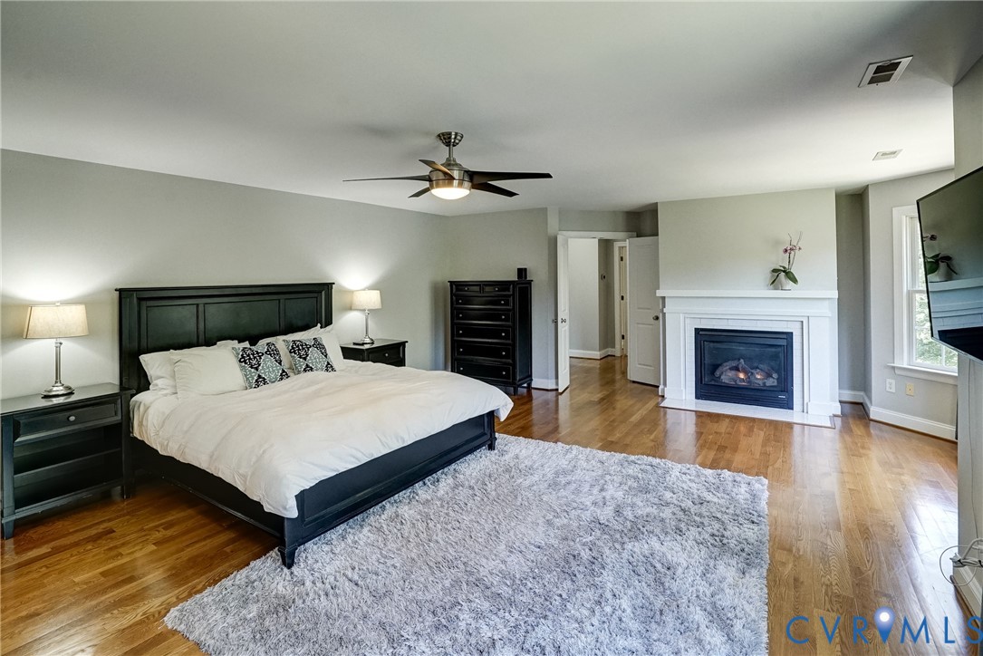 1295 Hermitage Road Manakin-Sabot, VA 23103 - Photo 41 of 55 a spacious bedroom with a large bed and a fireplace