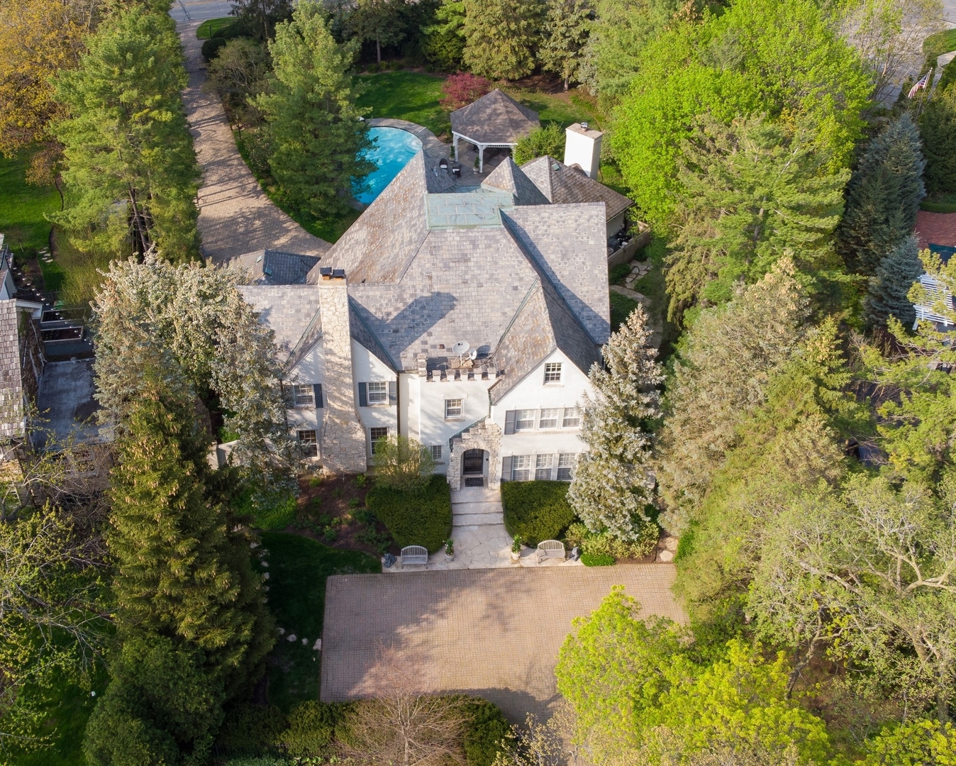 an aerial view of a house with a yard and garden