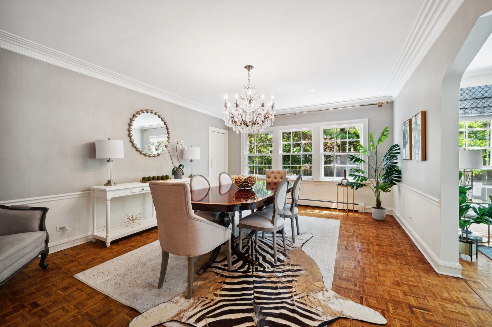 1140 Seneca Road Wilmette, IL 60091 - Photo 12 of 65 a dining room with wooden floor a chandelier a glass table and chairs