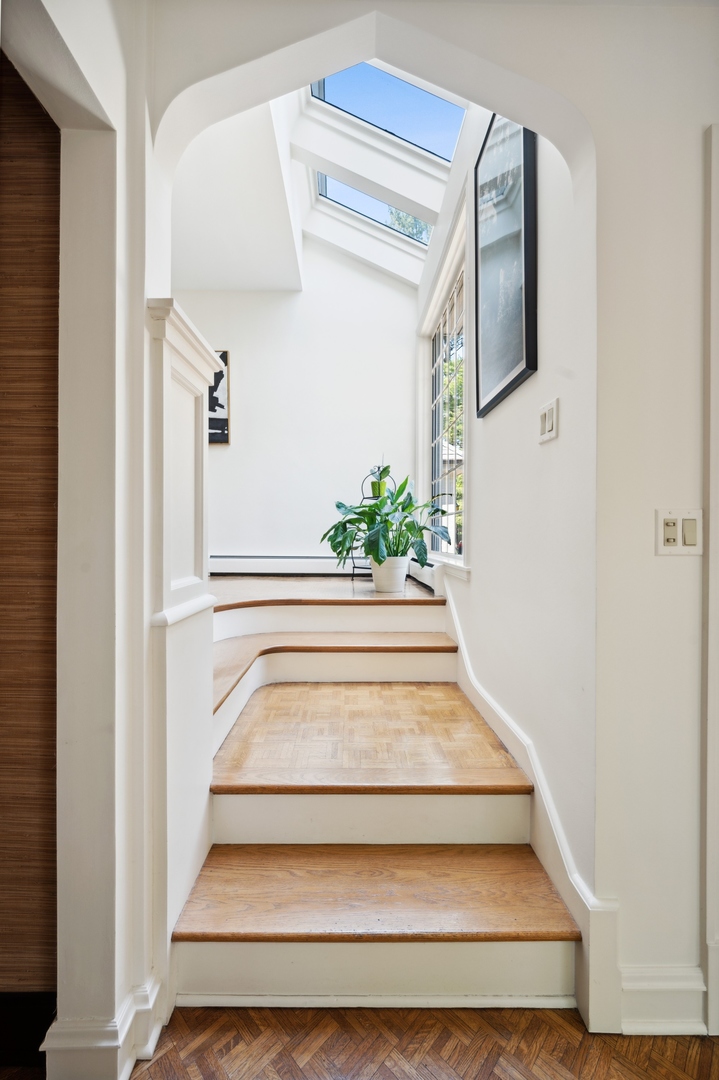 1140 Seneca Road Wilmette, IL 60091 - Photo 18 of 65 a view of staircase with white walls and a potted plant