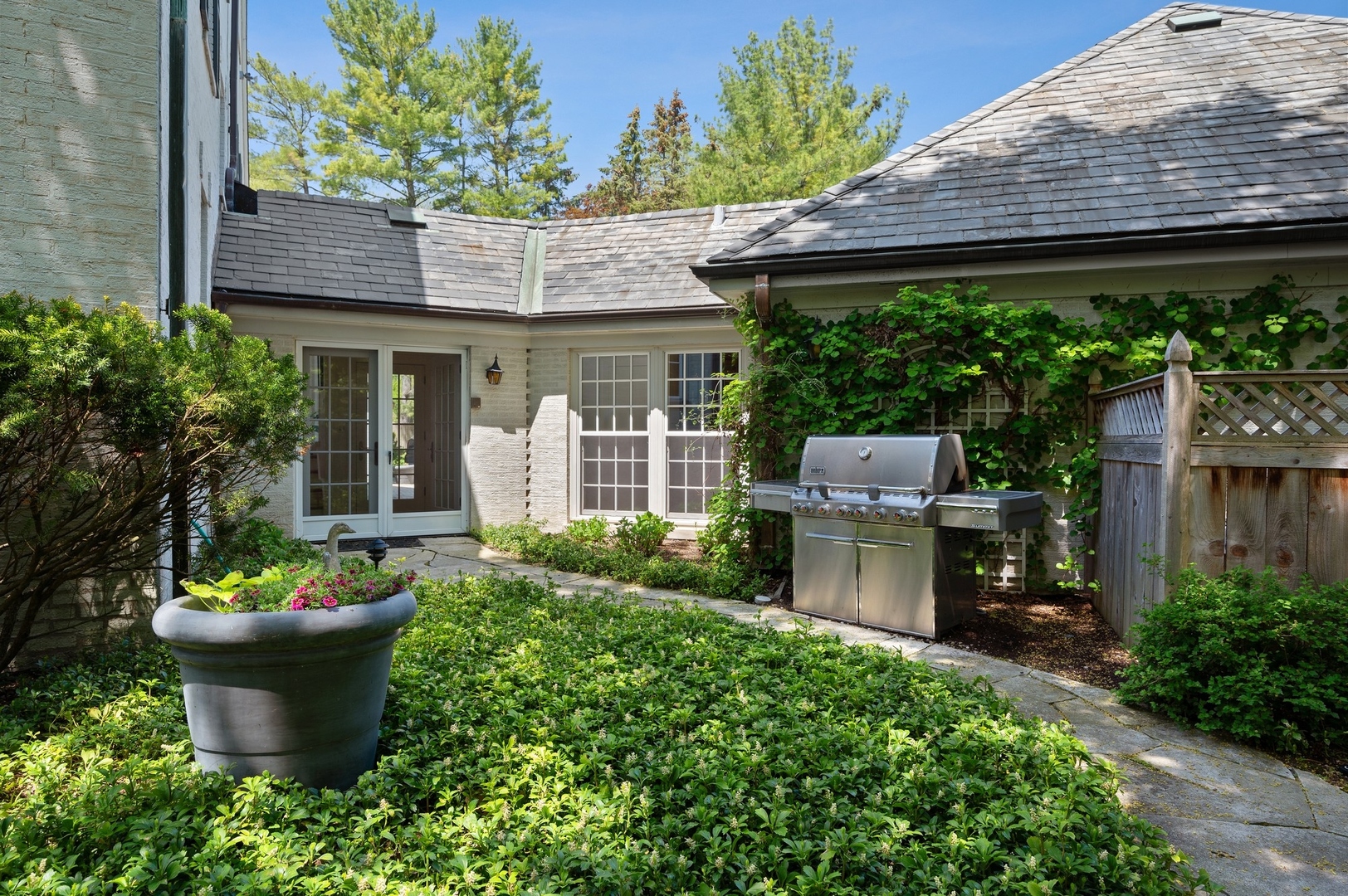 1140 Seneca Road Wilmette, IL 60091 - Photo 26 of 65 front view of a house with a garden