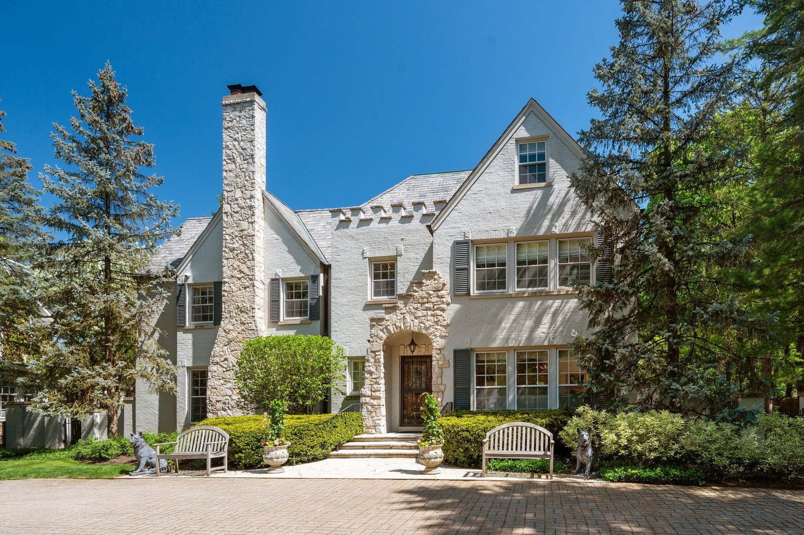 1140 Seneca Road Wilmette, IL 60091 - Photo 3 of 65 a front view of a house with a garden